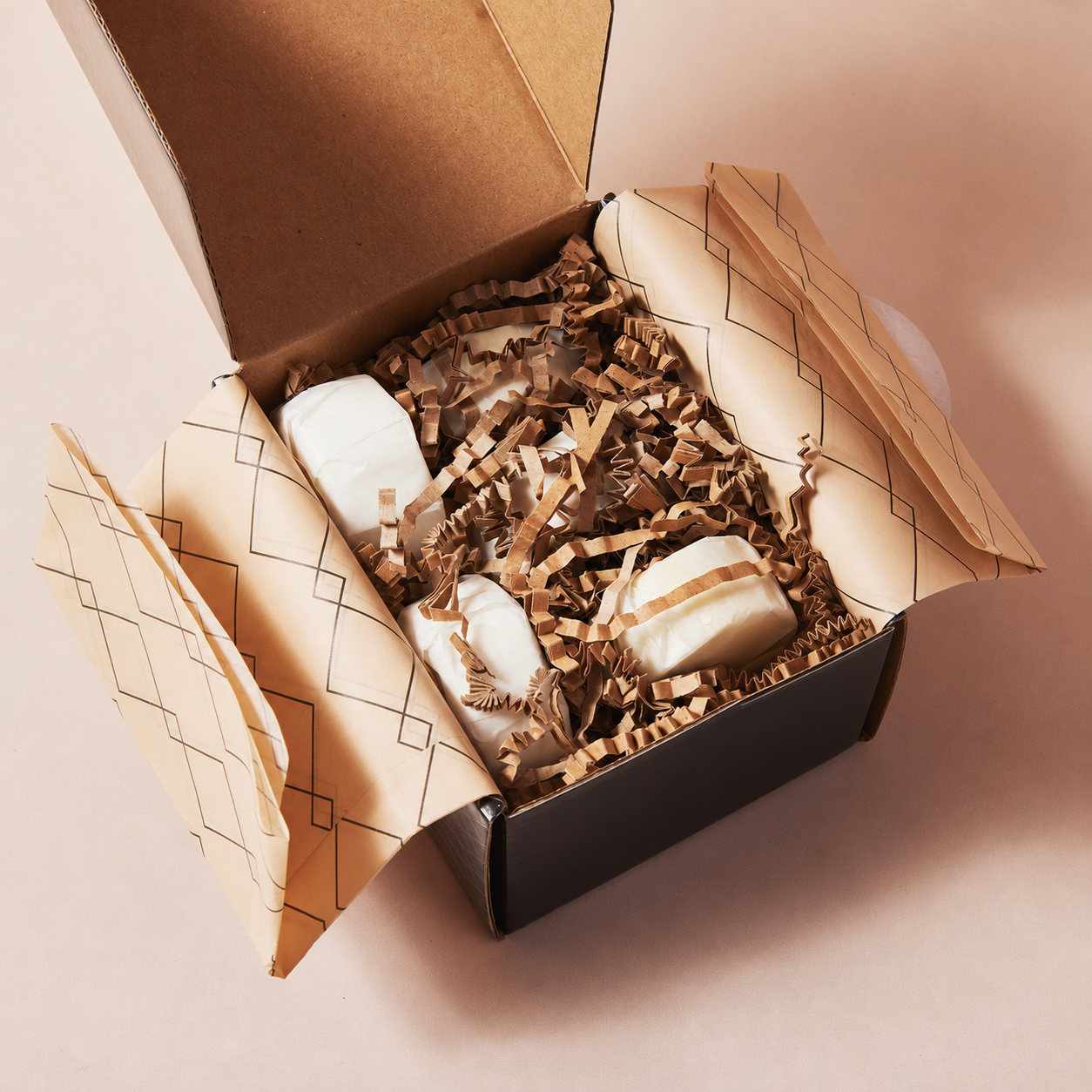 Open Sunday Steam gift box with aromatherapy shower steamers wrapped in patterned tissue paper and eco-friendly paper filling.